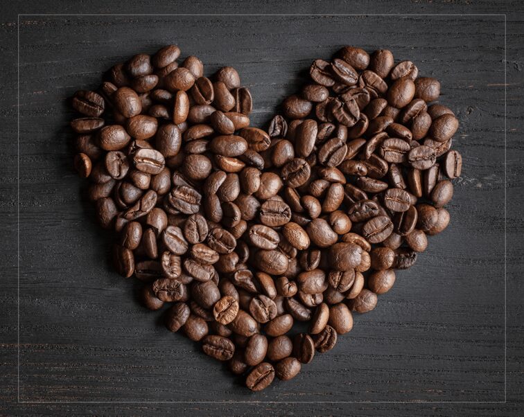 Heart-shaped arrangement of roasted coffee beans