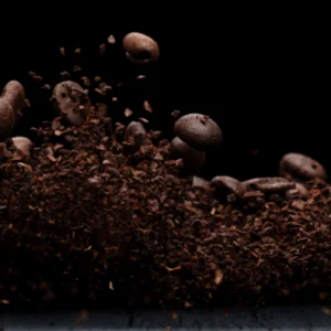 Roasted coffee beans and grounds mid-air
